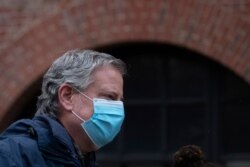 FILE - Mayor Bill de Blasio wears a mask while honoring health care workers at Brooklyn's Kings County Hospital Center during the coronavirus pandemic, in New York, April 24, 2020.