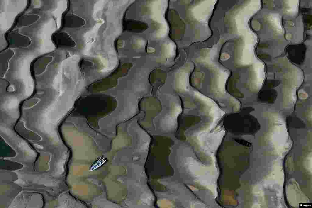 A drone view shows stranded boats over the sandbanks exposed due to drought at the Solimoes River, one of the largest tributaries of the Amazon River, during the most intense and widespread drought since 1950, near Manacapuru, Amazonas state, Sept. 30, 2024.