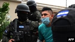 Members of the National Anti Maras and Gangs Force (FNAMP) arrest Jose Alejandro Nunez Cruz, alleged administrator of the criminal gang MS-13 at an exclusive residential area in Tegucigalpa, Honduras, Nov. 26, 2020.