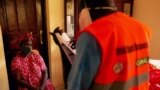 A member of the South Sudanese Ministry of Health Rapid Response Team questions to a woman for testing at her home as she recently contacted with a confirmed COVID-19 coronavirus case in Juba, South Sudan on April 14, 2020.