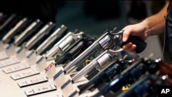 FILE - In this Jan. 19, 2016, file photo, handguns are displayed at the Smith & Wesson booth at a Las Vegas trade show. The Mexican government sued U.S. gun manufacturers and distributors, including some of the biggest names in guns like Smith & Wesson Brands.