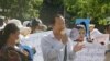 Rong Chhun, center, President of the Cambodian Trade Union Confederation, uses a megaphone during a protest near the prime minister's residence in Phnom Penh, Cambodia, Wednesday, July 29, 2020. (AP Photo/Heng Sinith)