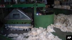 A worker performs maintenance work on machinery at the Wenzhou Tiancheng Textile Company, one of China's largest cotton recycling plants in Wenzhou in eastern China's Zhejiang province on March 20, 2024.