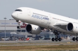 FILE - An Airbus A350 takes off at the aircraft builder's headquarters in Colomiers near Toulouse, France, Sept. 27, 2019.