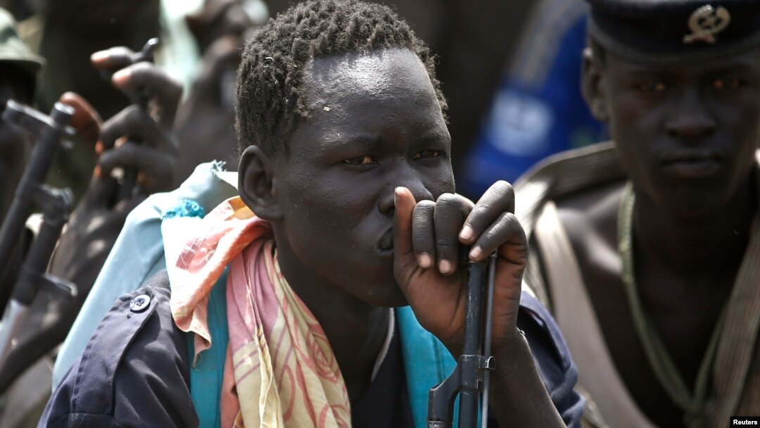 Rebel fighters listen to their commander in rebel-controlled territory in Upper Nile State, Feb. 15, 2014. 