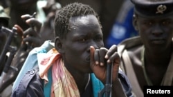 Rebel fighters listen to their commander in rebel-controlled territory in Upper Nile state, South Sudan on Feb. 15, 2014. 