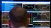 FILE - A trader looks at his screen as he works on the floor of the New York Stock Exchange, March 13, 2014.