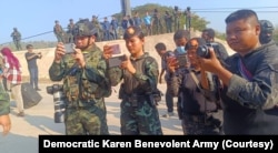 Thai Army soldiers photograph and film the 261 foreign nationals rescued from online scam operations in Myawaddy, Myanmar, as part of an escalating crackdown on human trafficking and cyber fraud along the border. (Courtesy - DKBA)