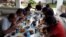 FILE - Indonesian sailors, who were kidnapped by the Abu Sayyaf militant group, eat a meal at a local government official's house after they were released from captivity in Jolo, Sulu in southern Philippines, May 2, 2016.