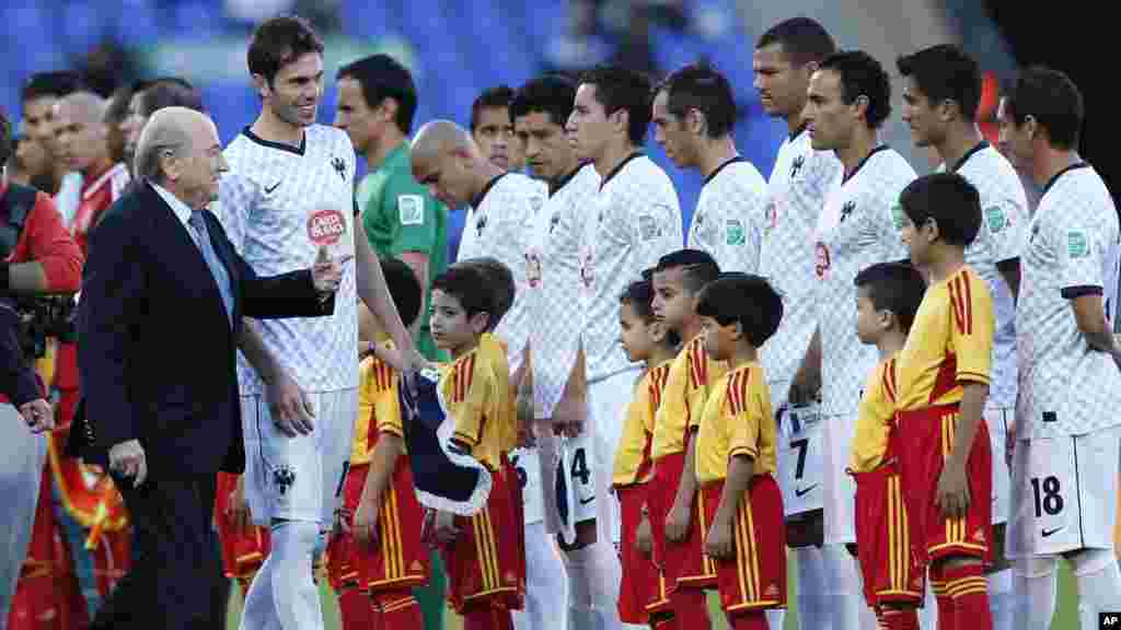 FIFA president Sepp Blatter welcomes the players of Monterrey prior to their match between Al Ahly SC and Monterrey FC at the Club World Cup soccer tournament in Morocco, December 18, 2013.