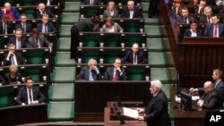 Poland's Foreign Minister Witold Waszczykowski bottom, standing) delivers an annual policy speech in parliament in Warsaw, Poland, Feb. 9, 2017.