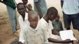 FILE - Sudanese boys pass the time in the Kakuma camp, in northern Kenya, April 24, 2000. Over 20,000 boys who were displaced or orphaned during two decades of civil war endured many hardships as they traveled on foot to refugee camps in Ethiopia and Kenya.