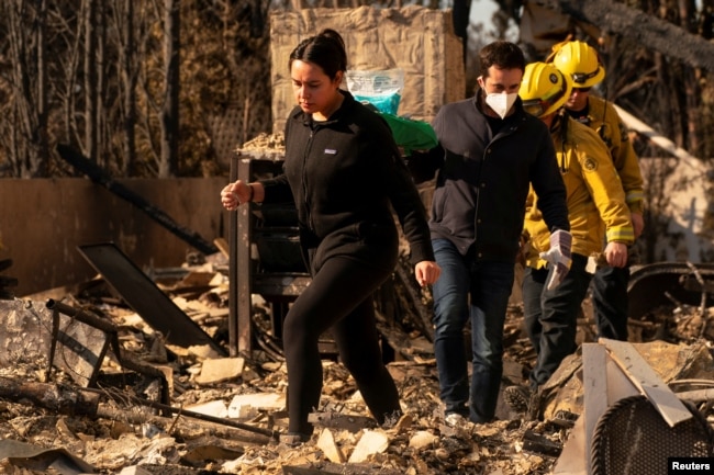 Victoria Medina walks through the remains of her parents’ home on Jan. 11, 2025. It was destroyed by the Palisades Fire in the Pacific Palisades neighborhood in Los Angeles.