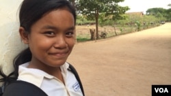 Kul Srey Mao stands in front of her school where First Lady Michelle Obama visited lady Friday to promote her 'Let Girls Learn' initiative. 