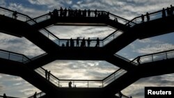 People tour the inside 'The Vessel,' a large public art sculpture made up of 155 flights of stairs at the Hudson Yards development, a residential, commercial, and retail space on Manhattan's West side in New York City, New York, U.S., May 26, 2019. 