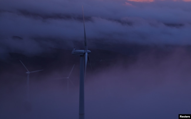 FILE - Wind turbines are surrounded by fog at a wind farm in the mountains of Galicia region, near Vilalba, Spain March 20, 2024. (REUTERS/Nacho Doce)