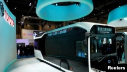 FILE - Toyota Motor Corp. displays the company's fuel cell bus Sora during media preview of the 45th Tokyo Motor Show in Tokyo, Japan, Oct. 25, 2017. 
