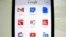 Google apps are shown on an Apple iphone 5 in this photo illustration in Encinitas, California, April 16, 2013. 