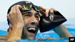 FILE - Michael Phelps reacts after the men's 100-meter butterfly final during the swimming competitions at the 2016 Summer Olympics, Aug. 12, 2016, in Rio de Janeiro, Brazil. 