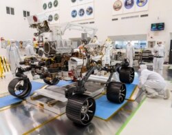 In a clean room at NASA's Jet Propulsion Laboratory in Pasadena, California, engineers observed the first driving test for NASA's Mars 2020 rover Perseveranceo, Dec. 17, 2019. (Credit: NASA/JPL-Caltech)