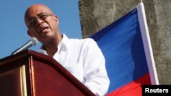 FILE - Haiti's President Michel Martelly addresses the audience during a memorial held for the victims of the 2010 earthquake in Titanyen, on the outskirts of Port-au-Prince, Jan. 12, 2015. 