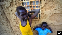 Jan. 6: Southern Sudanese boys staying in north Sudan wait at their house at the Hadj Yoasf district in Khartoum. After south Sudan votes as expected to secede from the north on Jan. 9, leaders of both countries must still resolve a daunting range of prac