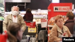 Senior citizens are seen shopping in a Delhaize supermarket as it opens an hour earlier only for people above 65 years old in an attempt to protect the most vulnerable from coronavirus risks, in Brussels, Belgium, March 18, 2020.