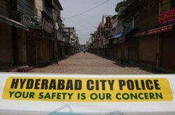A sign is displayed at a closed market during a lockdown imposed to curb the spread of the coronavirus in Hyderabad, India, May 13, 2021.