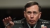 FILE - David Petraeus, former CIA director and four-star Army general, has agreed to plead guilty to mishandling classified information. He's shown at a 2012 Senate hearing with Lieutenant General Ronald Burgess in Washington, D.C. 