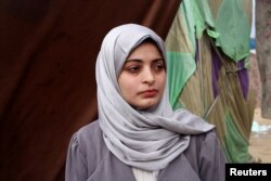 FILE - Aseel Abu Haddaf looks on at a tent camp where they shelter, in Rafah in the southern Gaza Strip January 28, 2024