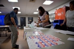 Voters sign in to cast their ballot at a polling place in Philadelphia, Pennsylvania, April 26, 2016.