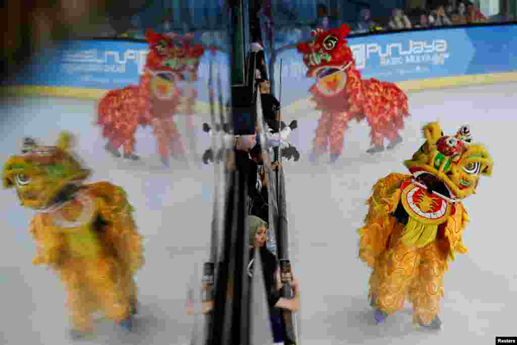 Youths perform Chinese Lion dance on figure skating during a show to celebrate the upcoming Lunar New Year, at a shopping mall in South Tangerang, on the outskirts of Jakarta, Indonesia.