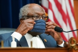 FILE - Committee Chairman Rep. James Clyburn, D-S.C., adjusts his face mask as he chairs a House Select Subcommittee on the Coronavirus Crisis hearing, in Washington, July 2, 2020.