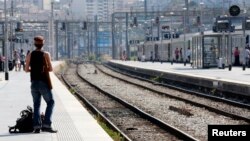 A commuter waits for a train during a nationwide strike by French SNCF railway workers at Marseille train station, June 12, 2014.