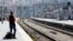 A commuter waits for a train during a nationwide strike by French SNCF railway workers at Marseille train station, June 12, 2014.