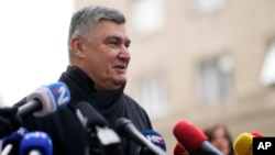 Incumbent President Zoran Milanovic talks to media after casting his ballot during a runoff vote for the Croatian presidential election at a polling station in Zagreb, Croatia, Jan. 12, 2025. 