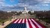 FILE - A large American flag is placed on the National Mall, with the US Capitol behind, ahead of the inauguration of President-elect Joe Biden and Vice President-elect Kamala Harris, Jan. 18, 2021.