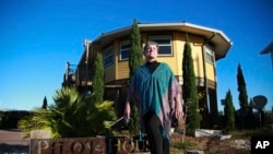 Bonny Paulson stands in front of her home in Mexico Beach, Fla. on Thursday, Oct. 19, 2023. The hurricane resistant house, designed by Deltec, was one of the few remaining structures left after Hurricane Michael hit the area in 2018.