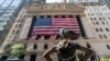 FILE - The "Fearless Girl" bronze sculpture looks toward the New York Stock Exchange, Sept. 21, 2020. 