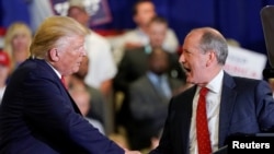 North Carolina’s 9th District Republican candidate Dan Bishop shakes hands with U.S. President Donald Trump during a campaign rally in Fayetteville, North Carolina, Sept. 9, 2019. 