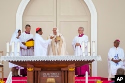 Pope Francis receives a gift from the Archbishop of Dili Cardinal Virgilio do Carmo da Silva at the end of a votive mass of the Blessed Virgin Mary Queen he presided over in Tasitolu, some 8 kilometers west of Dili, East Timor, Sept. 10, 2024.