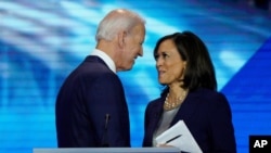 FILE - Democratic presidential candidate former Vice President Joe Biden, left, and then-candidate Sen. Kamala Harris, D-Calif. shake hands after a Democratic presidential primary debate.