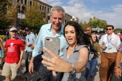 Democratic U.S. presidential candidate and New York City Mayor Bill de Blasio takes a photo with a fairgoer at the Iowa State Fair in Des Moines, Iowa, Aug. 11, 2019.