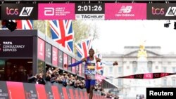 FILE — Kenya's Kelvin Kiptum celebrates as he crosses the finish line to win the elite men's race in London, Britain, on April 23, 2023