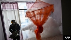 FILE - A worker fumigates a house against the Aedes aegypti mosquito to prevent the spread of dengue fever in Piura, northern Peru, on June 11, 2023. The Peruvian government will declare a state of health emergency in 20 of its 25 regions as of Feb. 27, 2024, 