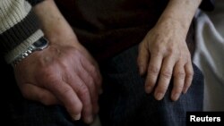 Kanemasa Ito, 72, holds hands with his 68-year-old wife Kimiko, who was diagnosed with dementia 11 years ago, at their home in Kawasaki, south of Tokyo, Japan, April 6, 2016.Dementia affects nearly 5 million Japanese citizens and is forecast to affect 7 million by 2025.