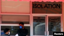Men wear protective mask as a preventive measure against coronavirus, as they stand outside the Isolation ward at the Pakistan Institute of Medial Sciences (PIMS) in Islamabad, Pakistan March 15, 2020. REUTERS/Waseem Khan NO RESALES. NO ARCHIVES
