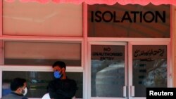 Men wear protective mask as a preventive measure against coronavirus, as they stand outside the Isolation ward at the Pakistan Institute of Medial Sciences (PIMS) in Islamabad, Pakistan March 15, 2020. REUTERS/Waseem Khan NO RESALES. NO ARCHIVES