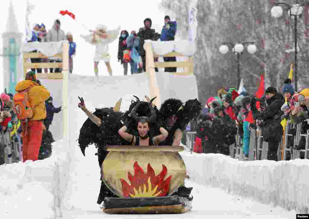 Participants ride down a slope during the &quot;Sunnyfest&quot; festival of unusual sledges&#160;in the town of Mamadysh in the Republic of&#160;Tatarstan, Russia, Feb. 6, 2021.
