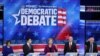 FILE - Sen. Elizabeth Warren (D-MA) (C) speaks as Sen. Amy Klobuchar (D-MN) (L), South Bend, Indiana Mayor Pete Buttigieg, former Vice President Joe Biden and Sen. Bernie Sanders (I-VT) (R) listen, Nov. 20, 2019 in Atlanta, Georgia. 